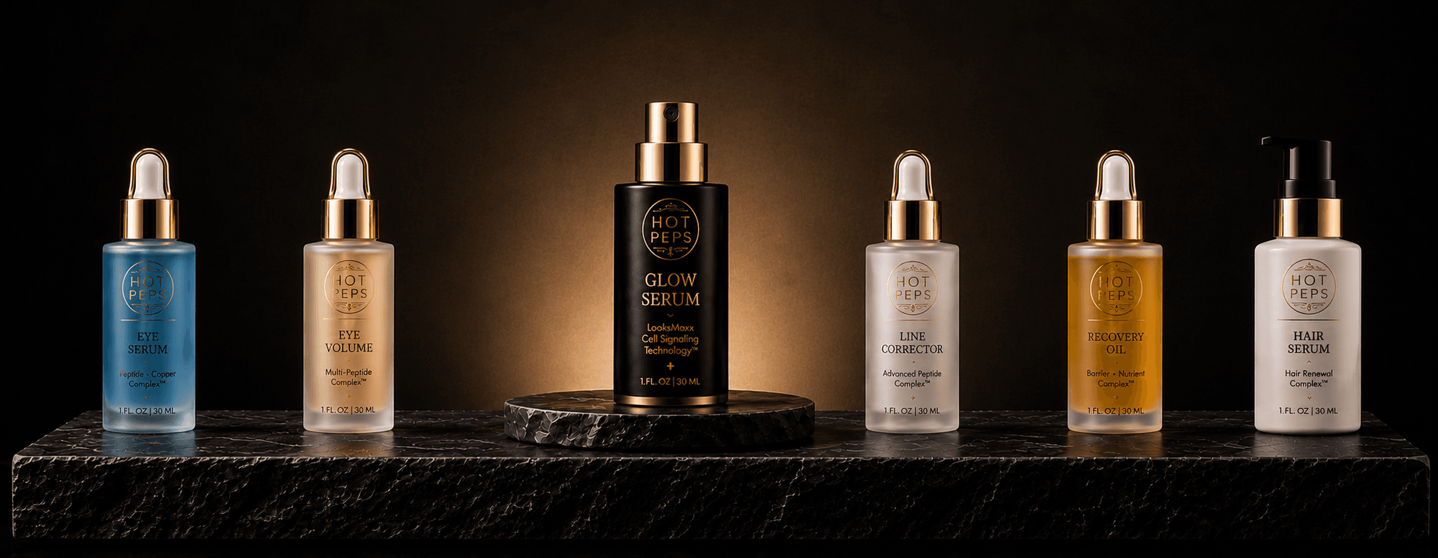 The Hot Peps System — Eye Serum, Eye Volume, Glow Serum, Line Corrector, Recovery Oil, and Hair Serum on marble.